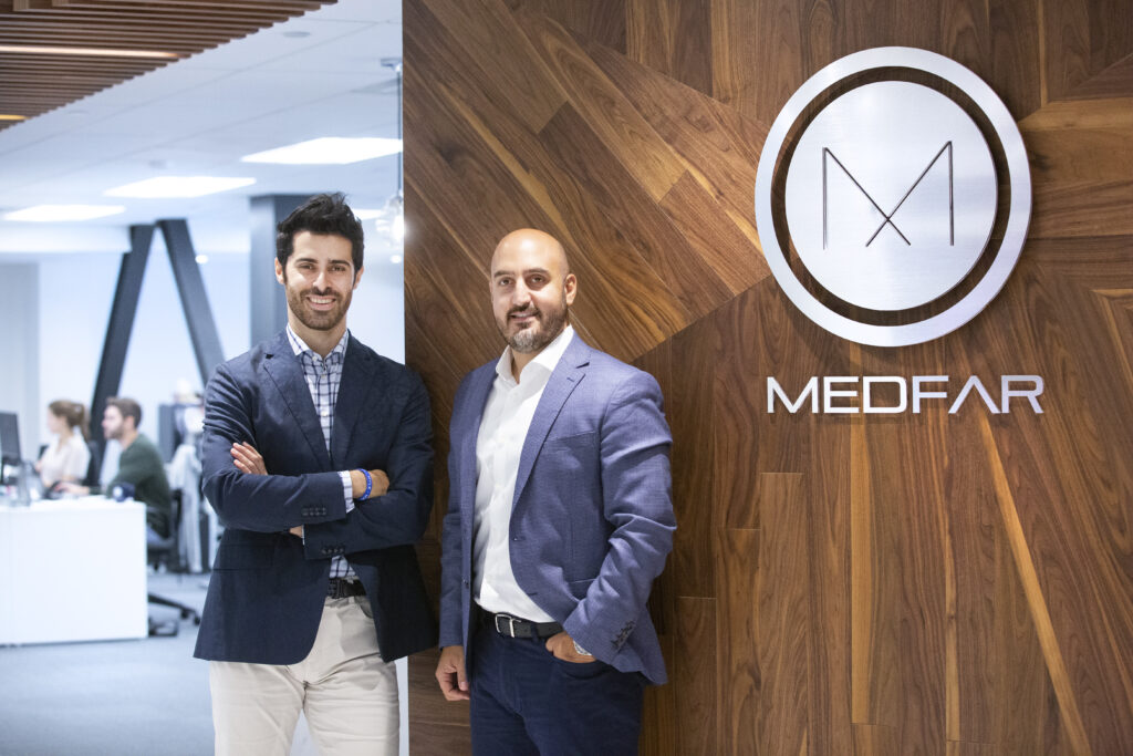 MEDFAR founders Elias Farah and Patrick Issid stand in front of MEDFAR sign